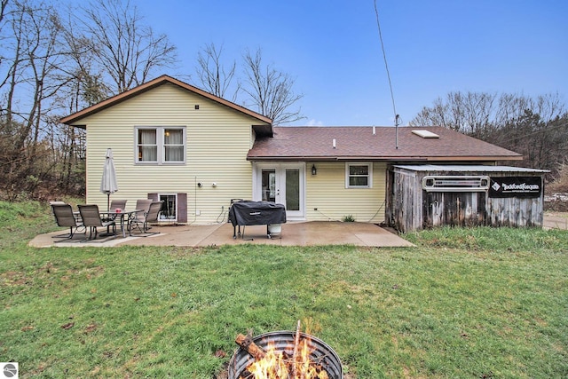 7809 Potter Rd, Bear Lake, MI 49614 - rear view of house with french doors, a yard, a patio, an outdoor fire pit, and a shingled roof