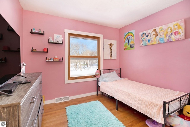 7809 Potter Rd, Bear Lake, MI 49614 - bedroom featuring baseboards, light wood finished floors, and visible vents
