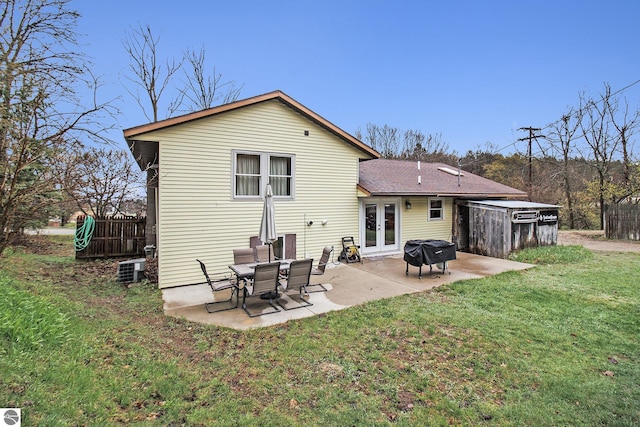 7809 Potter Rd, Bear Lake, MI 49614 - rear view of property featuring french doors, central AC, fence, a yard, and a patio area