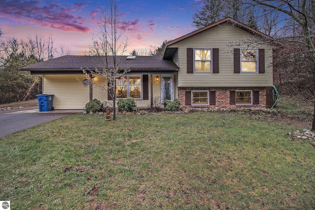 7809 Potter Rd, Bear Lake, MI 49614 - tri-level home with a front yard, brick siding, and aphalt driveway