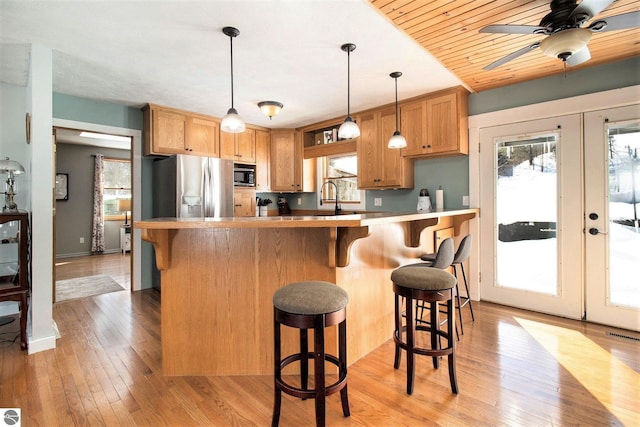 7809 Potter Rd, Bear Lake, MI 49614 - kitchen with french doors, a sink, light wood-type flooring, ceiling fan, and appliances with stainless steel finishes