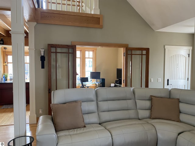 4130 W Dodge Springs Trl, Maple City, MI 49664 - living area featuring vaulted ceiling, ornate columns, and wood finished floors