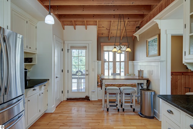 4130 W Dodge Springs Trl, Maple City, MI 49664 - kitchen with light wood finished floors, freestanding refrigerator, beam ceiling, wainscoting, and wooden ceiling