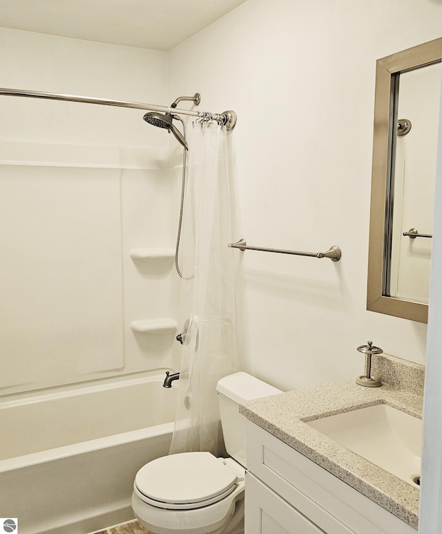 bathroom with toilet, vanity, and shower / tub combination