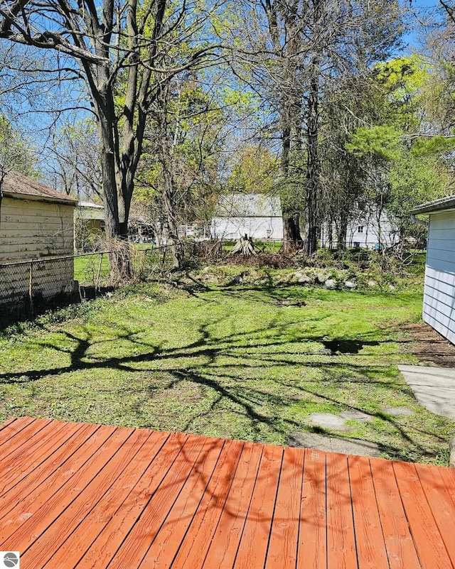 wooden deck with a yard and fence