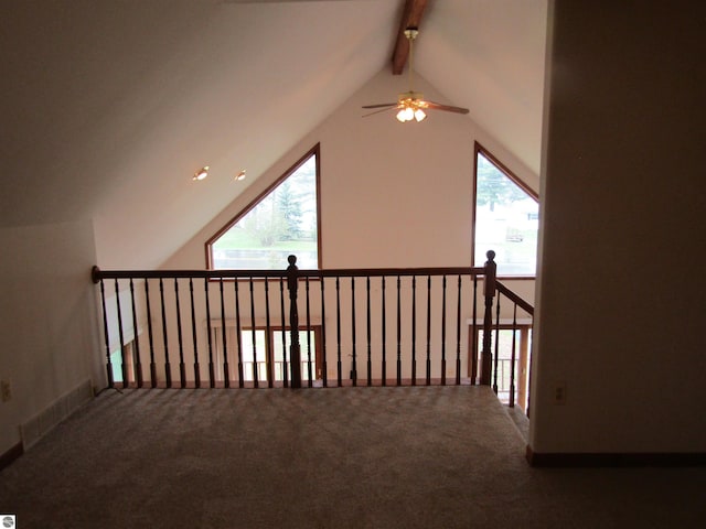 additional living space featuring vaulted ceiling with beams, a ceiling fan, and carpet floors