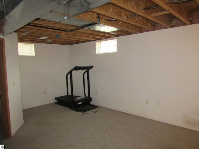 below grade area featuring carpet flooring and plenty of natural light