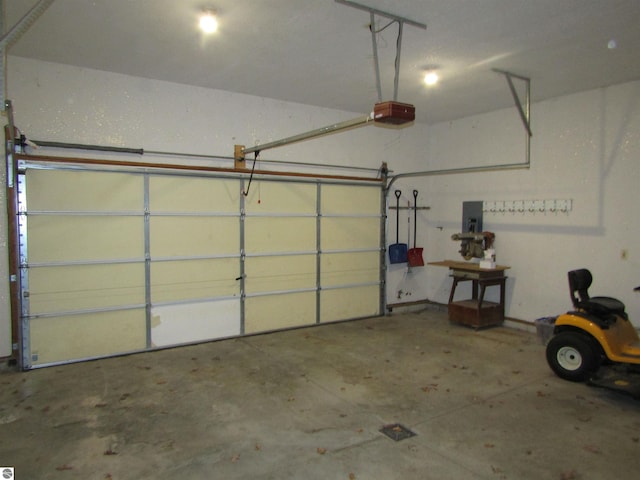 garage with electric panel and a garage door opener