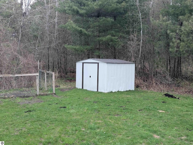view of shed featuring a view of trees