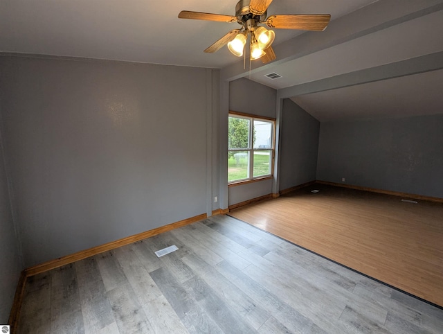 bonus room featuring vaulted ceiling, a ceiling fan, visible vents, and wood finished floors