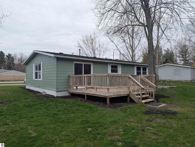 back of house featuring a lawn, crawl space, and a wooden deck