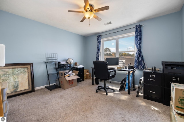office featuring carpet, visible vents, baseboards, and a ceiling fan