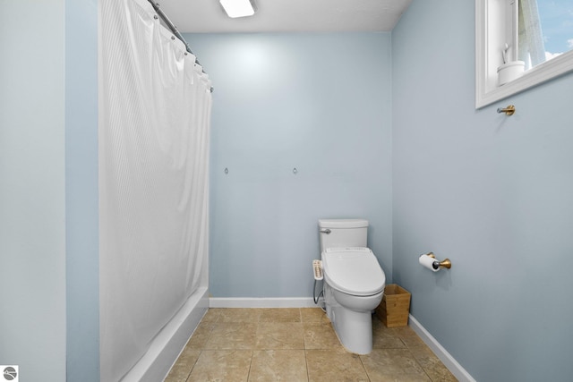 bathroom with toilet, baseboards, a shower with curtain, and tile patterned flooring