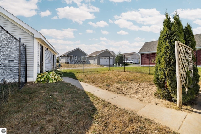 view of yard featuring fence and a residential view