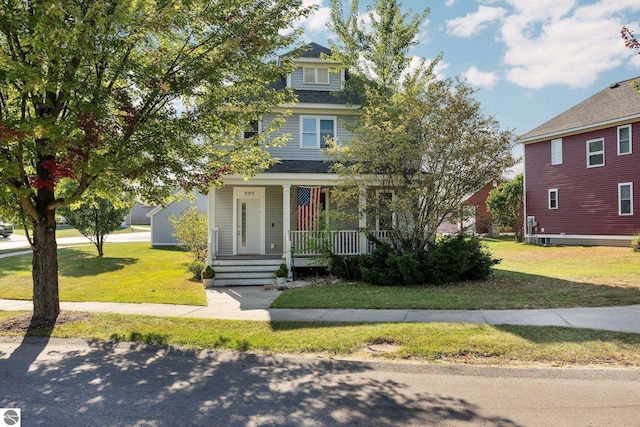 american foursquare style home with a porch and a front yard