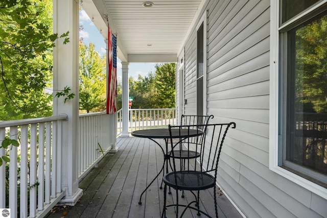 wooden terrace featuring covered porch