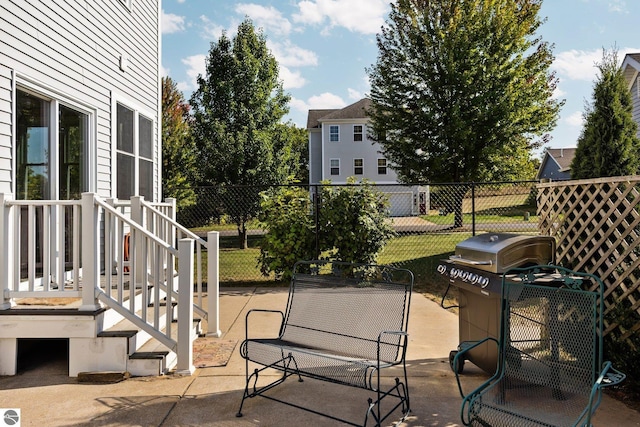view of patio / terrace featuring a grill and fence