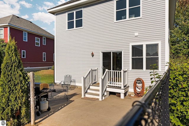back of property featuring a patio and fence