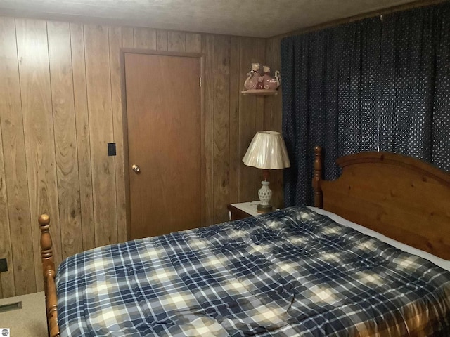 bedroom with wood walls