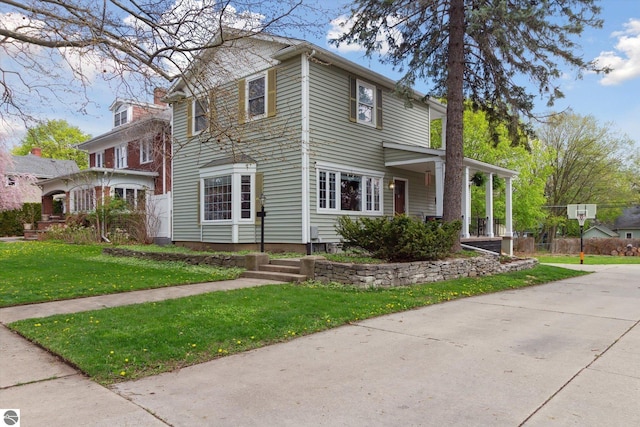 view of front of home with a front lawn and a porch