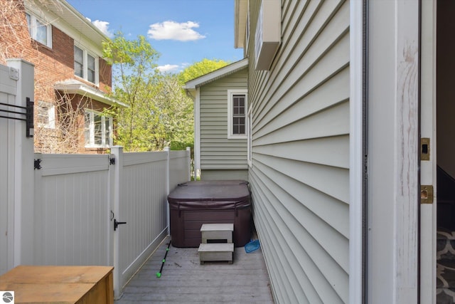 exterior space featuring a hot tub and a deck