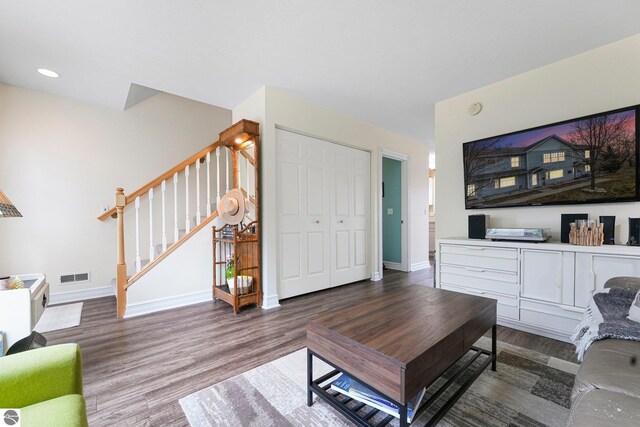 715 Lake Ave Unit 17-C, Traverse City, MI 49684 - living room with stairway, baseboards, visible vents, and wood finished floors