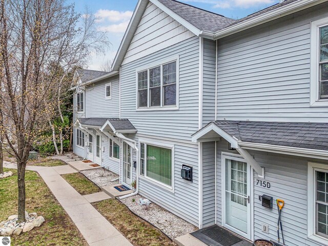 715 Lake Ave Unit 17-C, Traverse City, MI 49684 - view of property with roof with shingles