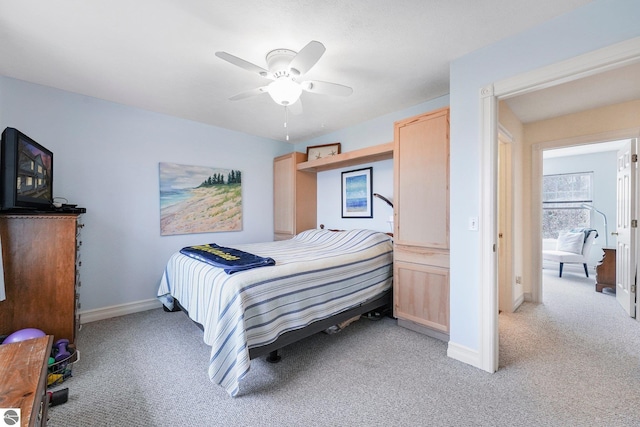 715 Lake Ave Unit 17-C, Traverse City, MI 49684 - bedroom featuring baseboards, ceiling fan, and light colored carpet