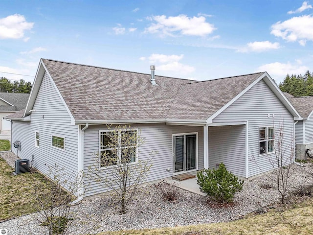 4620 Black Bear Dr Unit 49, Traverse City, MI 49685 - back of property featuring central AC unit, roof with shingles, and a patio