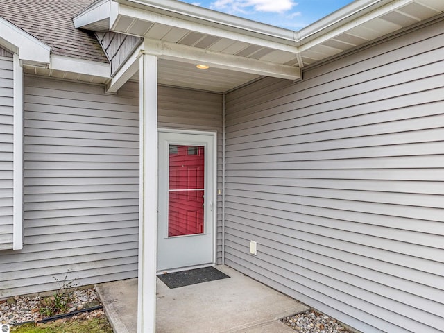 4620 Black Bear Dr Unit 49, Traverse City, MI 49685 - doorway to property with roof with shingles