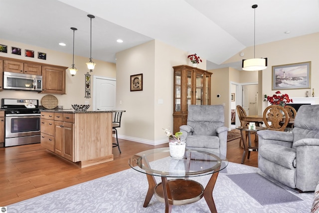 4620 Black Bear Dr Unit 49, Traverse City, MI 49685 - living area with light wood-style flooring, baseboards, lofted ceiling, and recessed lighting