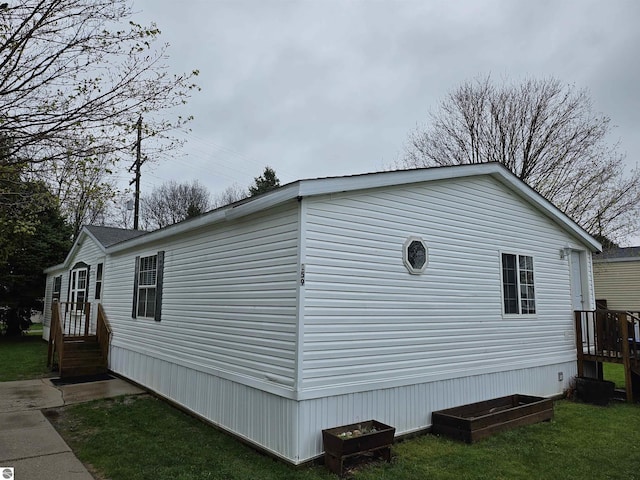 view of home's exterior with a lawn