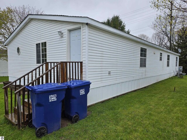 view of property exterior featuring a lawn