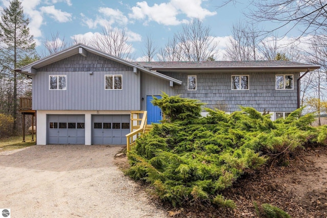 8822 Bahle Rd, Suttons Bay, MI 49682 - bi-level home featuring driveway and a garage