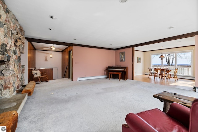 8822 Bahle Rd, Suttons Bay, MI 49682 - living area featuring crown molding, carpet, baseboard heating, and a baseboard heating unit