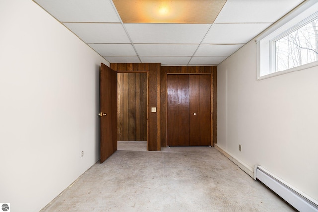 8822 Bahle Rd, Suttons Bay, MI 49682 - unfurnished bedroom featuring a paneled ceiling, baseboard heating, and concrete flooring