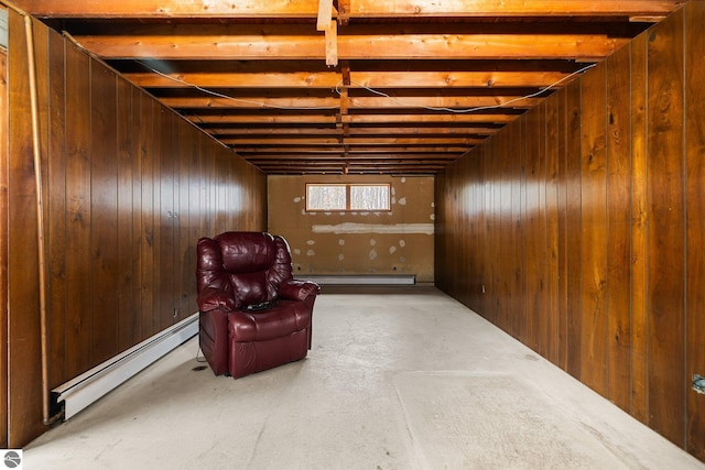 8822 Bahle Rd, Suttons Bay, MI 49682 - unfurnished room featuring finished concrete floors, wood walls, baseboard heating, and a baseboard heating unit
