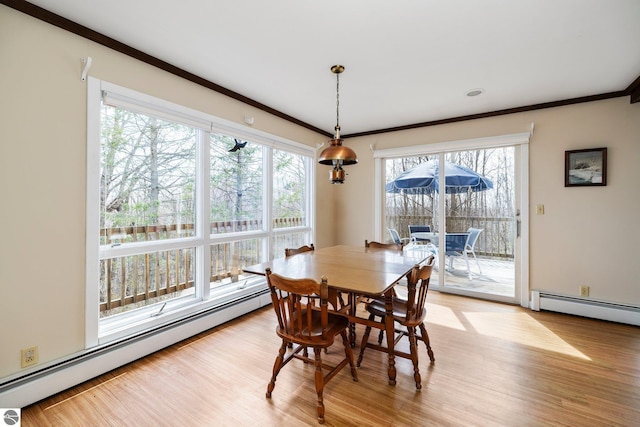 8822 Bahle Rd, Suttons Bay, MI 49682 - dining space featuring light wood finished floors, a healthy amount of sunlight, and baseboard heating