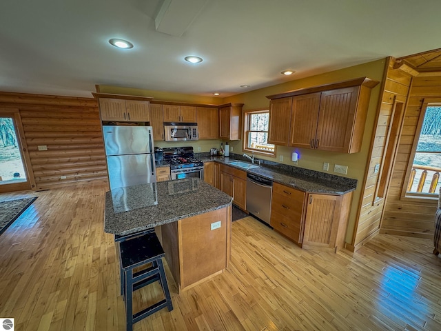 9184 S M-37, Wellston, MI 49689 - kitchen featuring brown cabinets, light wood-style floors, appliances with stainless steel finishes, and a sink