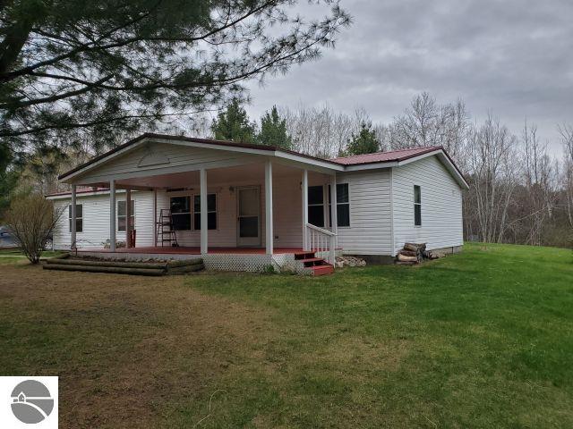 6626 Terry Ln, Hale, MI 48739 - rear view of property with a lawn, covered porch, and metal roof