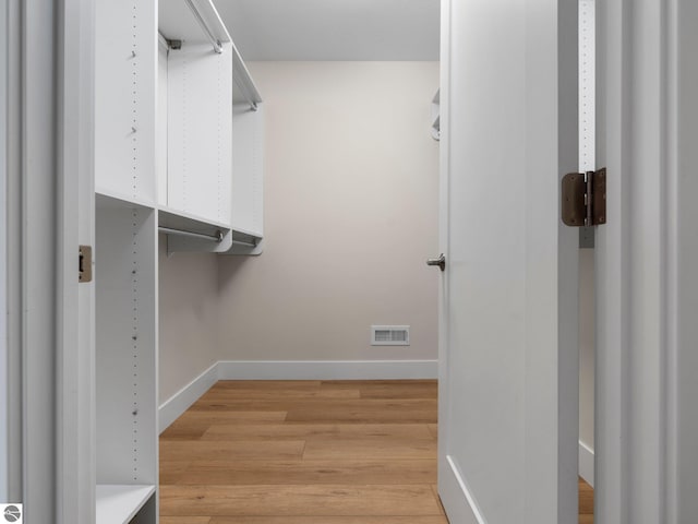 spacious closet with light wood finished floors