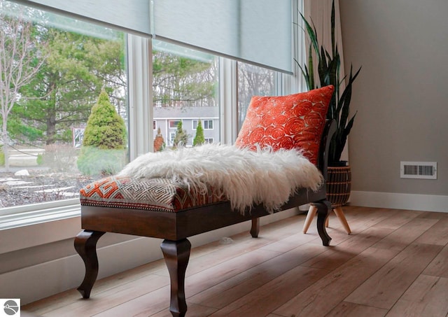 living area featuring hardwood / wood-style floors and baseboards