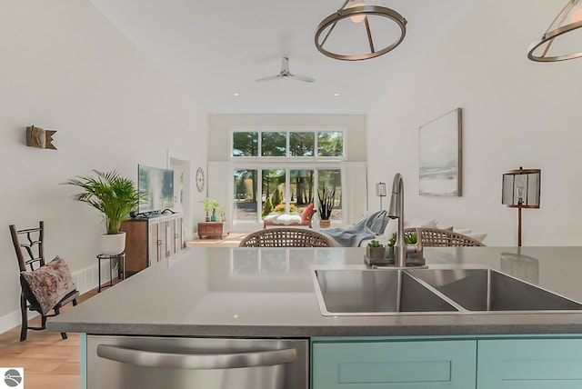 kitchen with dishwasher, a sink, light wood-style floors, a ceiling fan, and high vaulted ceiling