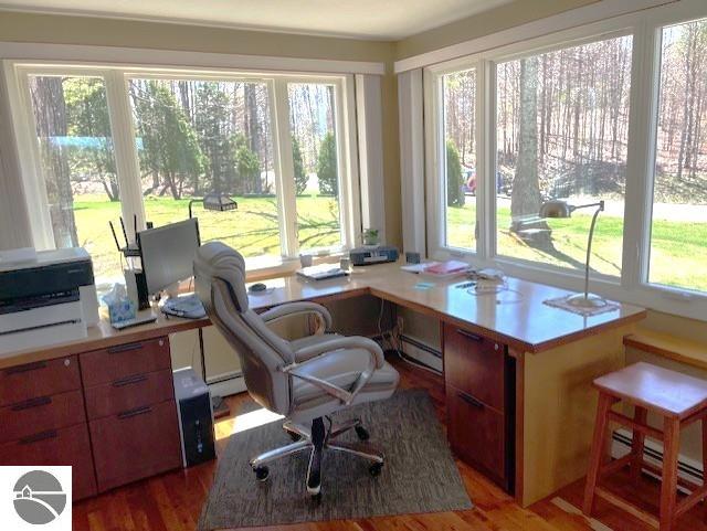 3312 Zimmerman Rd, Traverse City, MI 49685 - home office featuring baseboard heating and wood finished floors