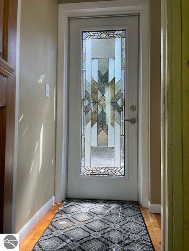 3312 Zimmerman Rd, Traverse City, MI 49685 - doorway featuring baseboards and light wood-type flooring