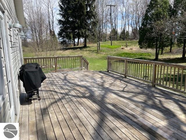 3312 Zimmerman Rd, Traverse City, MI 49685 - wooden deck with a lawn and grilling area