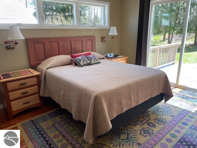 3312 Zimmerman Rd, Traverse City, MI 49685 - bedroom featuring access to exterior and wood finished floors