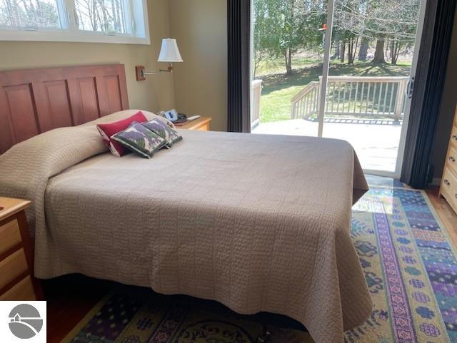 3312 Zimmerman Rd, Traverse City, MI 49685 - bedroom with access to outside and wood finished floors