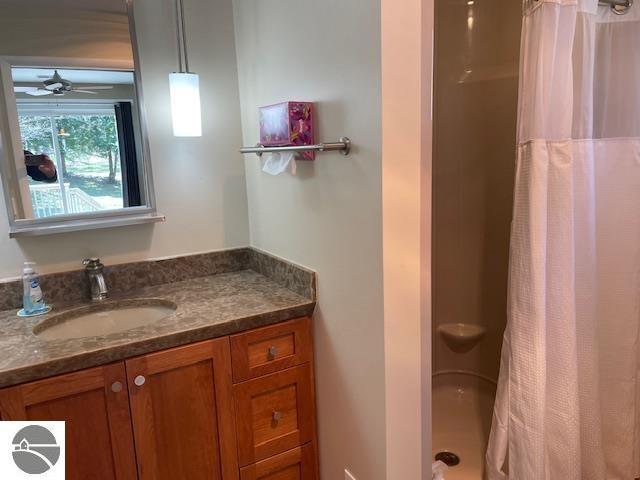 3312 Zimmerman Rd, Traverse City, MI 49685 - full bath with vanity, a shower with curtain, and ceiling fan