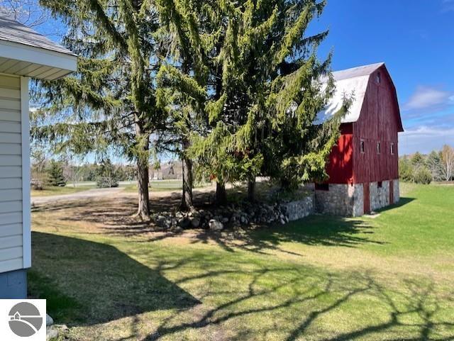 3312 Zimmerman Rd, Traverse City, MI 49685 - view of grassy yard featuring a barn and an outbuilding